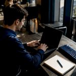 Indie developer typing AI prompts at home desk