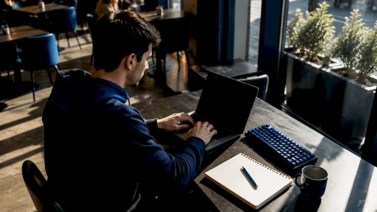 Indie developer typing AI prompts at home desk